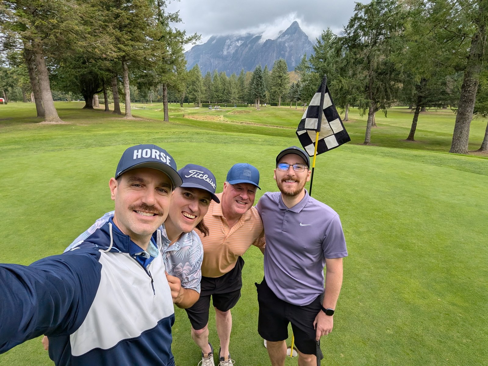 Group with Mount Si in the background and a checkered flag